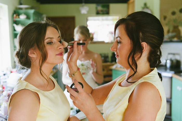 bridesmaids doing each other's make-up